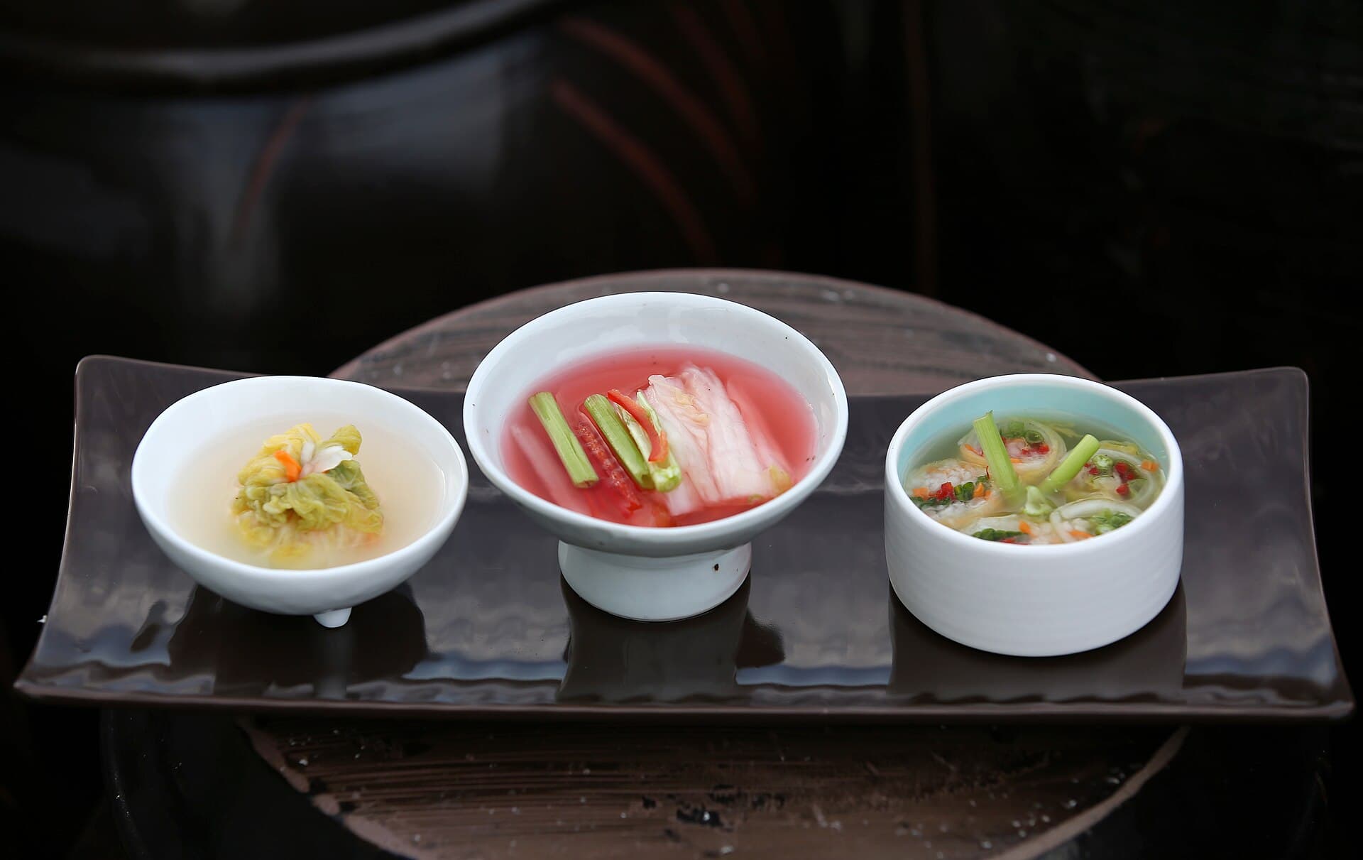 A bowl of pale kimchi prepared in a kitchen.