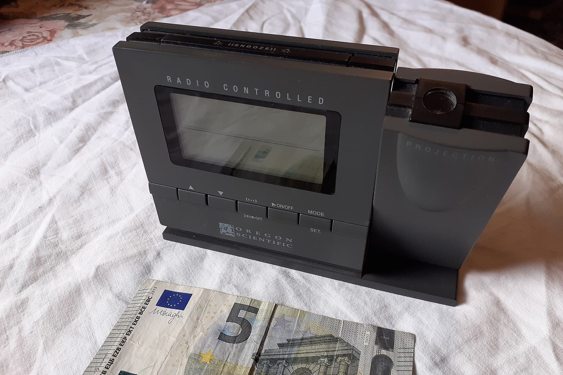 A digital alarm clock on a bedside table.
